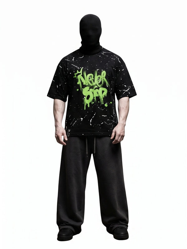 "NEVER STOP" Oversized Streetwear T-Shirt – All-Over Splatter Print (Black)